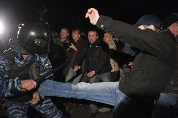 Manifestante é visto agredindo policiais durante protesto xenófobo em Moscou, na Rússia, após o assassinato de um jovem ser atribuído a um imigrante do Cáucaso(Imagem:reprodução)
